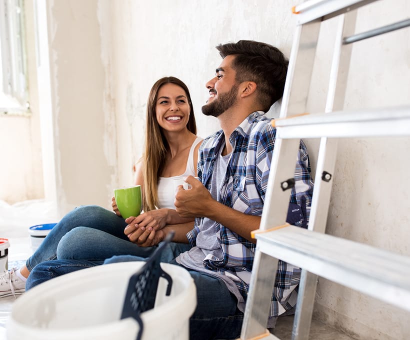 an image of a man and a woman homeowners smiling